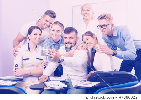 students and female professor taking selfie students and female professor taking selfie 47886322