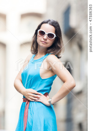 Girl walking in city streets Girl walking in city streets 47886363