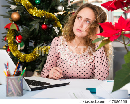 Worried woman working with laptop Worried woman working with laptop 47886366