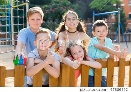 Glad kids posing at the playground and thumbs up 47886522