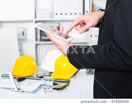 Man working and touching screen Man working and touching screen 47886848