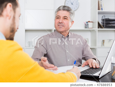 Men sign credit agreement Men sign credit agreement 47886953