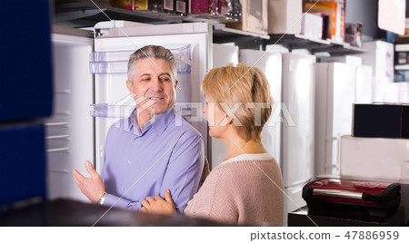 Pretty mature married couple choose for themselves refrigerator Pretty mature married couple choose for themselves refrigerator 47886959