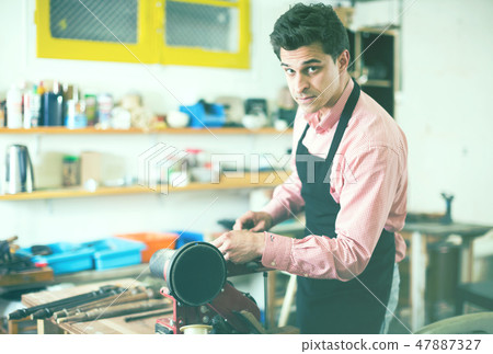 Craftsman working on woodworking machine Craftsman working on woodworking machine 47887327