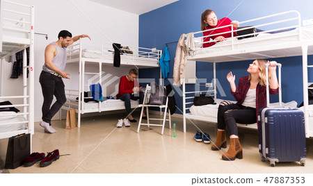 Young people interacting in hostel 47887353