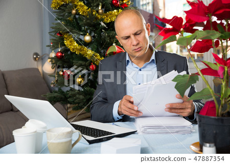 Concerned man working with laptop 47887354