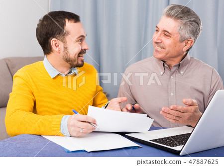 Man and sales manager discuss contract Man and sales manager discuss contract 47887625