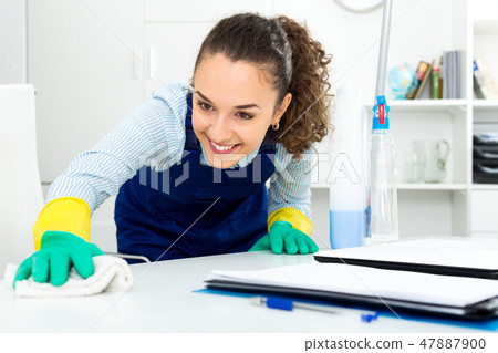 Woman with supplies cleaning in office 47887900