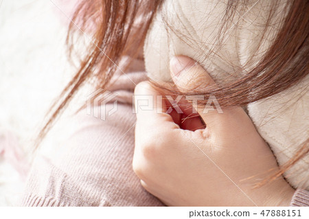 A woman holding a lying down cushion A woman holding a lying down cushion 47888151