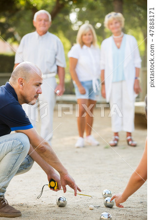 Mature people playing bocce Mature people playing bocce 47888171