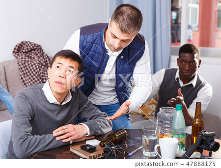 Chagrined man with friends Chagrined man with friends 47888175