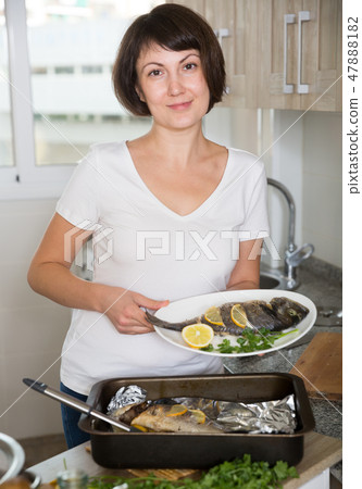 Housewife demonstrating dorado fish Housewife demonstrating dorado fish 47888182
