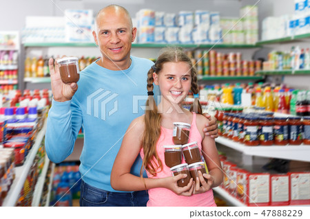 cheerful father doing shopping with preteen girl in supermarket cheerful father doing shopping with preteen girl in supermarket 47888229