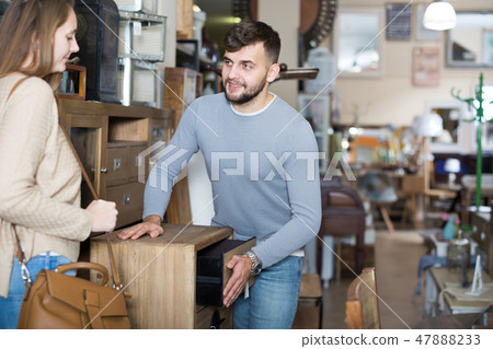 Guy with girlfriend choosing bedside chest 47888233