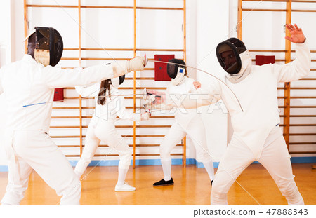men and women fencers posing with foils togethe men and women fencers posing with foils togethe 47888343