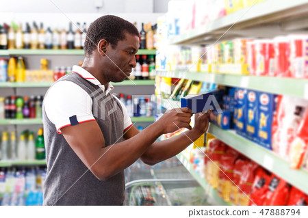 African man choosing pasta African man choosing pasta 47888794