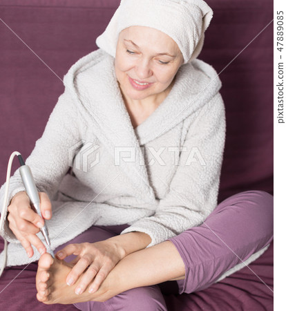 Woman doing pedicure Woman doing pedicure 47889085