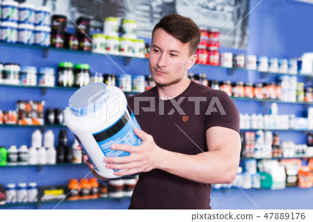 guy looking for necessary food supplements 47889176