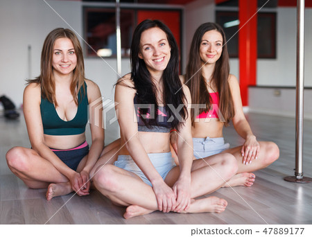 Women relaxing in pole fitness class 47889177