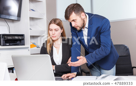 Administrator and seller at workplace in showroom 47889333