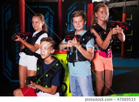 Girls and boys posing with laser pistols Girls and boys posing with laser pistols 47889533