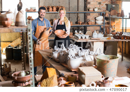 Two glad craftsmen with ceramic 47890017