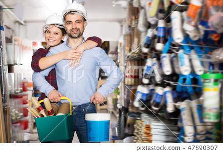 Adult female with man in helmet with instruments 47890307