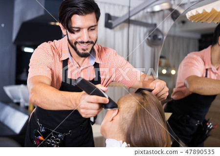 hairdresser working with hair clipper hairdresser working with hair clipper 47890535