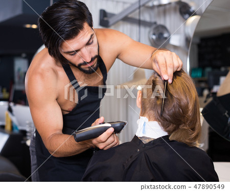 hairdresser working with hair clipper hairdresser working with hair clipper 47890549
