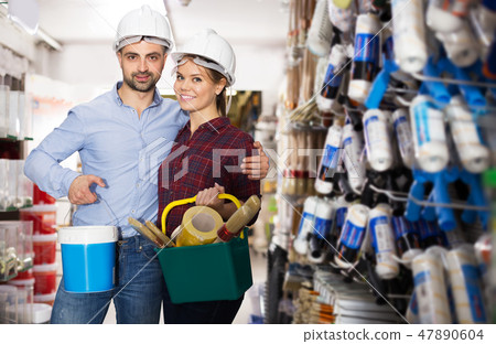 Couple buying paint and instruments 47890604