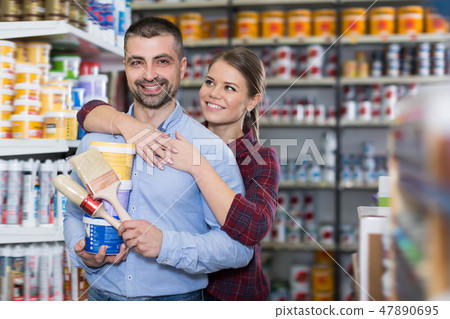 Glad woman and man with paint and brushes 47890695