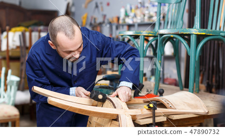 Craftsman repairing antique furniture Craftsman repairing antique furniture 47890732