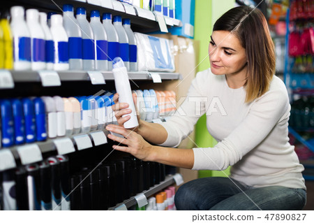 Girl customer looking for effective deodorant in supermarket 47890827
