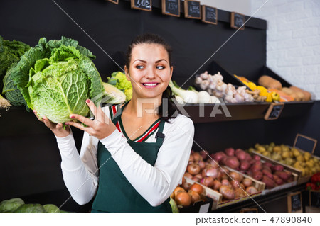 Woman choosing cabbage in grocery shop 47890840