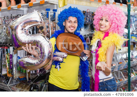 Family couple preparing for fest and choosing clown wigs 47891006