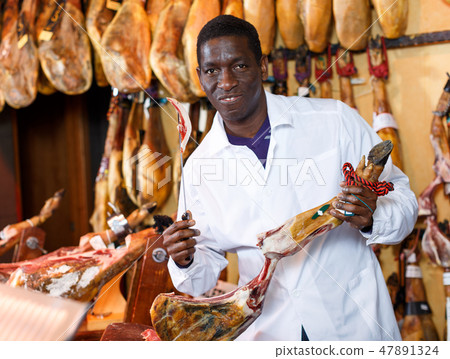 Salesman checking quality of ham Salesman checking quality of ham 47891324