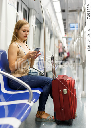 Woman using phone inside subway 47891359