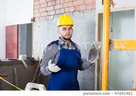 Builder ready is plastering the wall Builder ready is plastering the wall 47891481