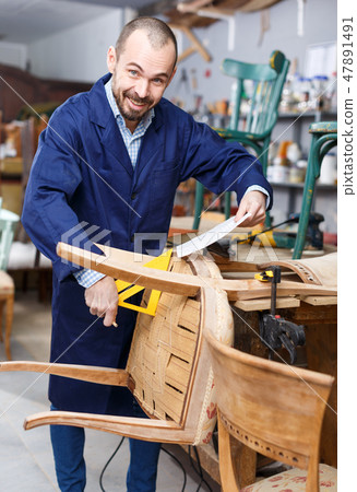 Carpenter repairing antique chair Carpenter repairing antique chair 47891491