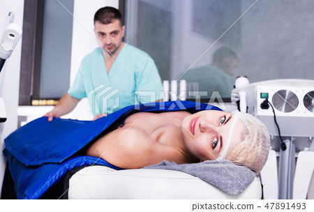 Woman receiving professional hardware body treatment in clinic Woman receiving professional hardware body treatment in clinic 47891493