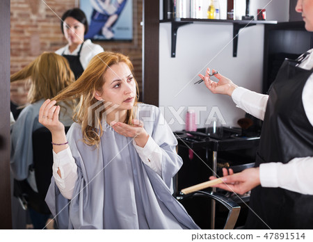 Unhappy woman in hairdress salon Unhappy woman in hairdress salon 47891514