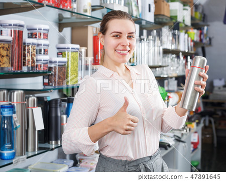woman is satisfied with the purchase of a thermos 47891645