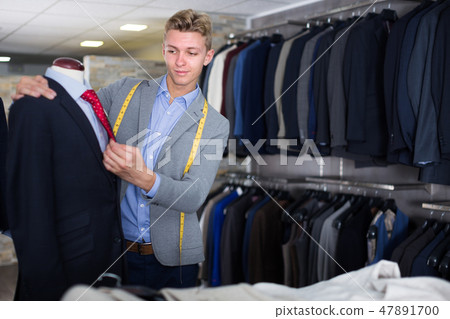 man seller measuring business style jacket 47891700