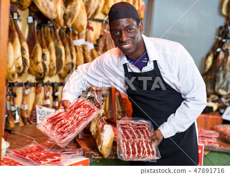Seller recommending iberian ham 47891716