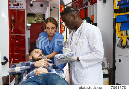 Paramedic giving patient logbook for signature 47891878