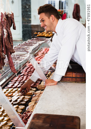 Seller in grocery shop 47891981