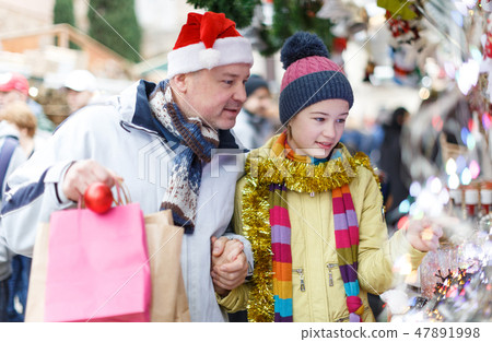 Girl with father shopping on Christmas market Girl with father shopping on Christmas market 47891998