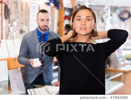 Female consumer trying chainlet with pendants Female consumer trying chainlet with pendants 47892006