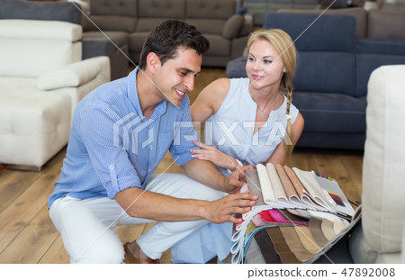 Happy family who are choosing colors for new sofa Happy family who are choosing colors for new sofa 47892008