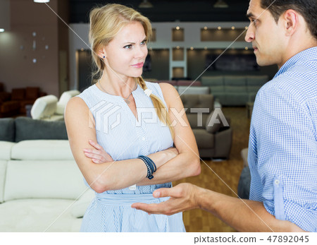 Woman unpleasantly surprised by prices for furniture 47892045